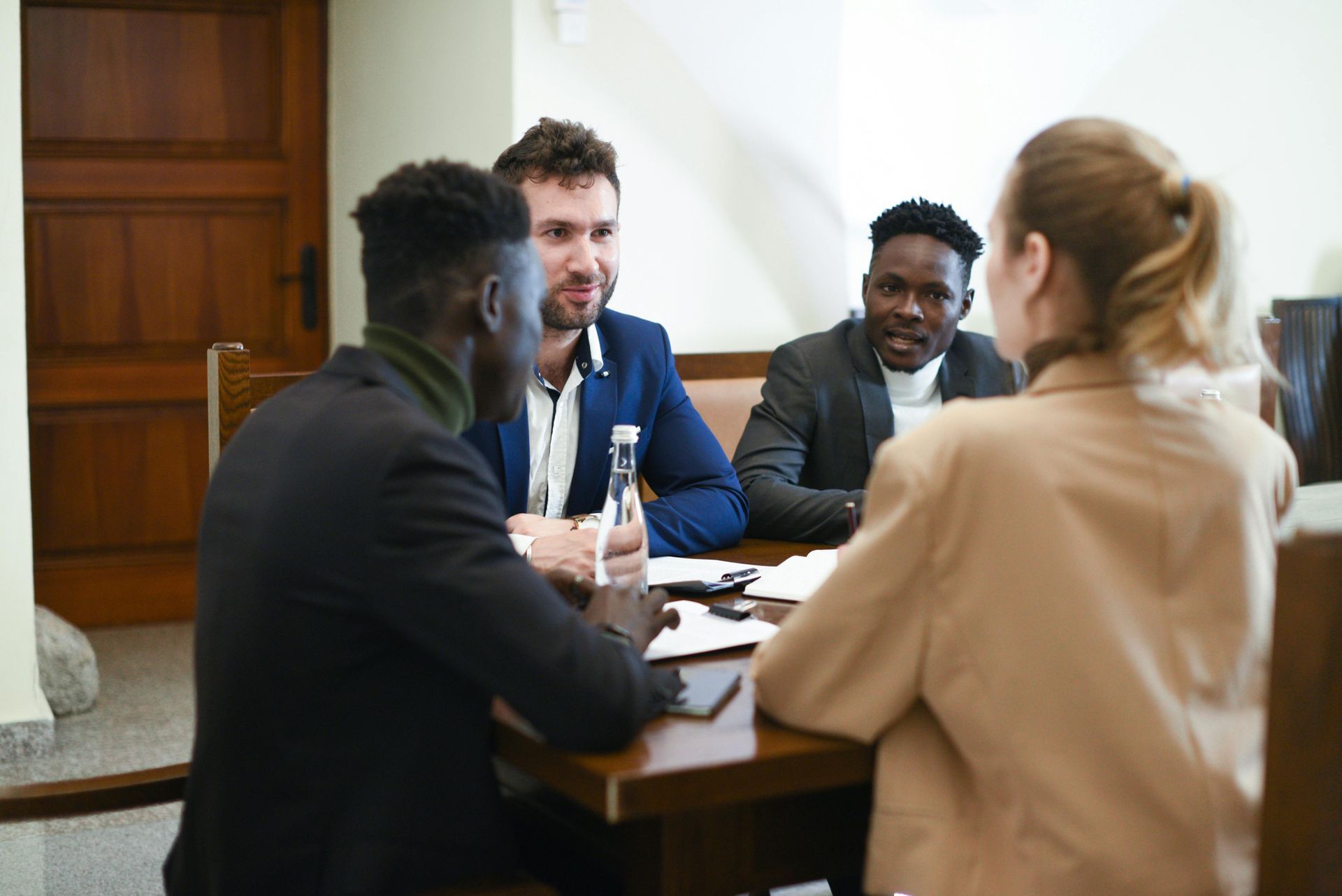 A professional meeting with clients discussing legal documents at a public notary office.