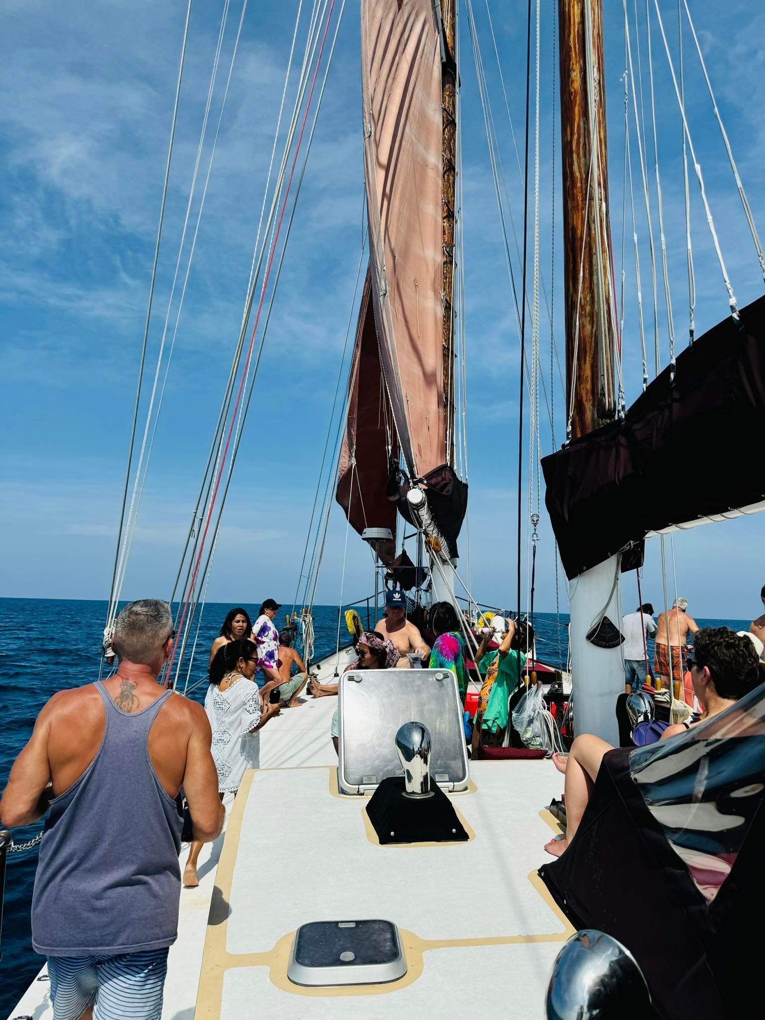 A group of people are on a boat in the ocean.