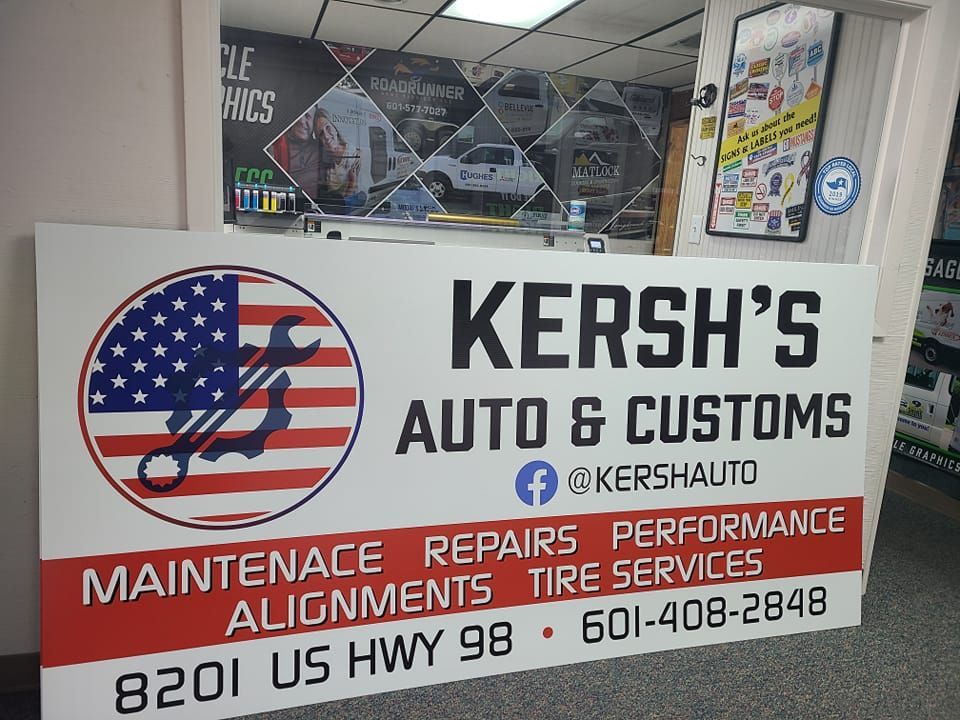 A sign for Kersh’s Auto & Customs at 8201 US Hwy 98, listing services and phone number 601-408-2848.