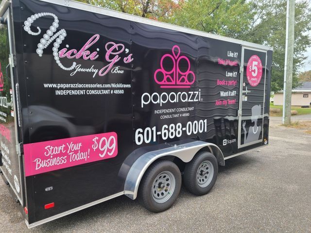 Black Paparazzi jewelry mobile trailer with pink logo, contact info, and 