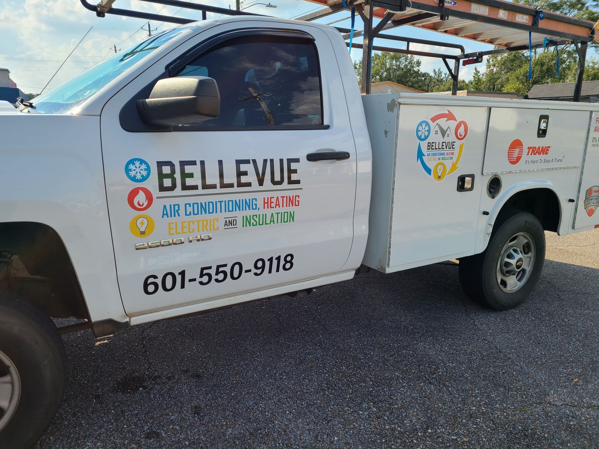 A white Bellevue service truck featuring contact information and company logos for HVAC and electrical services.
