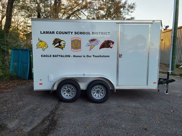 A white utility trailer branded with 