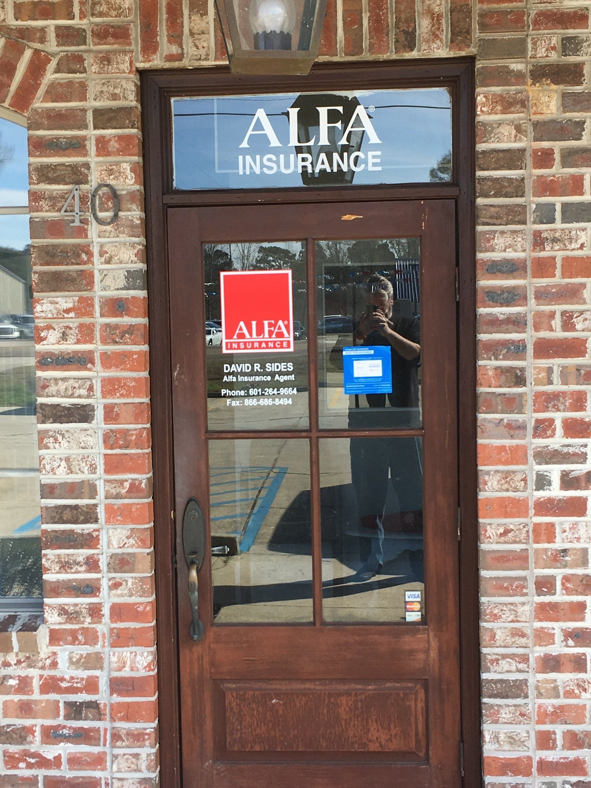 A brown wooden door with a glass window and 