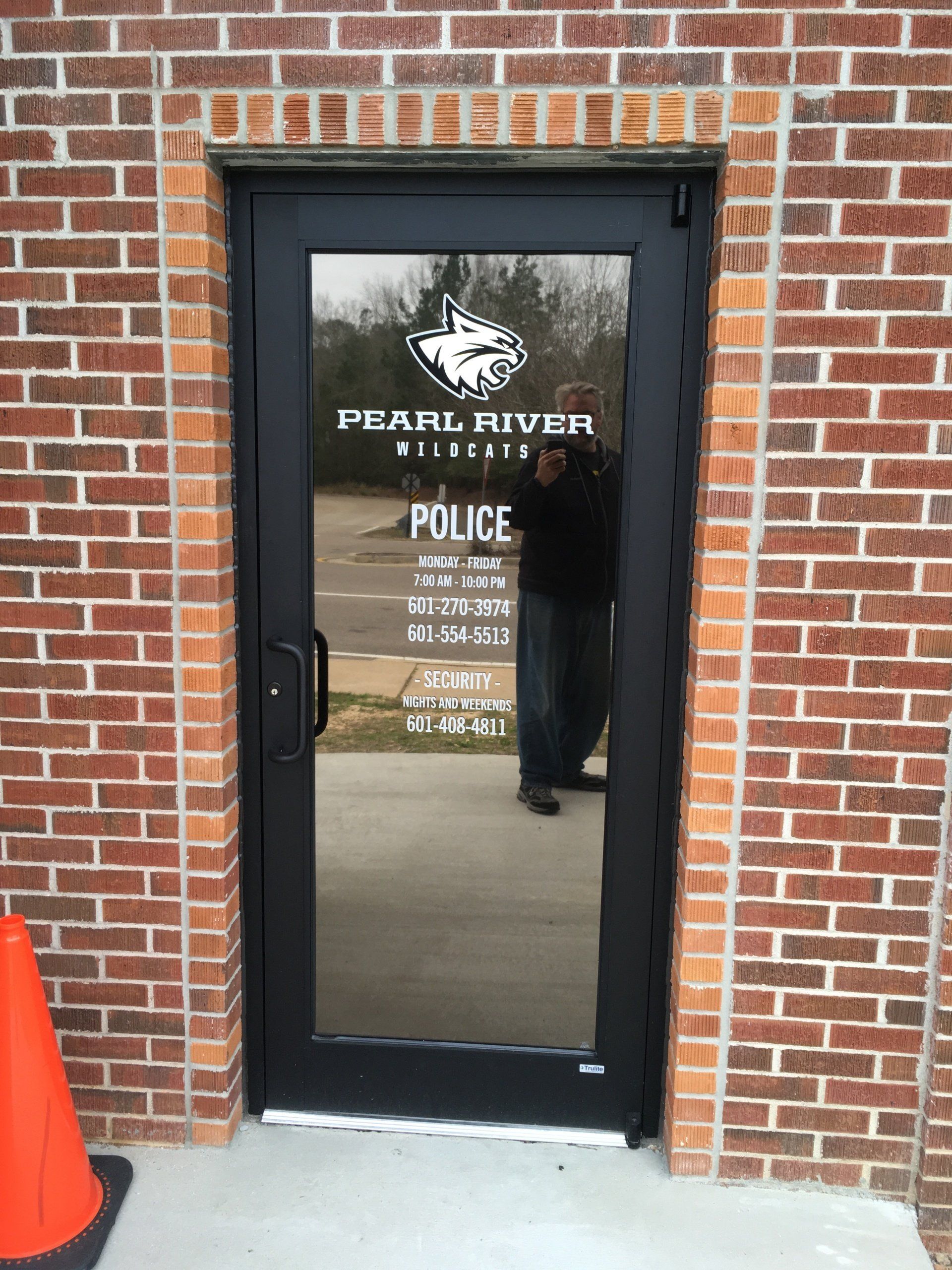 A black door labeled 