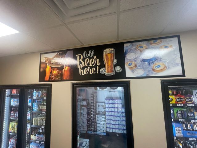 A sign above store refrigerators reads 