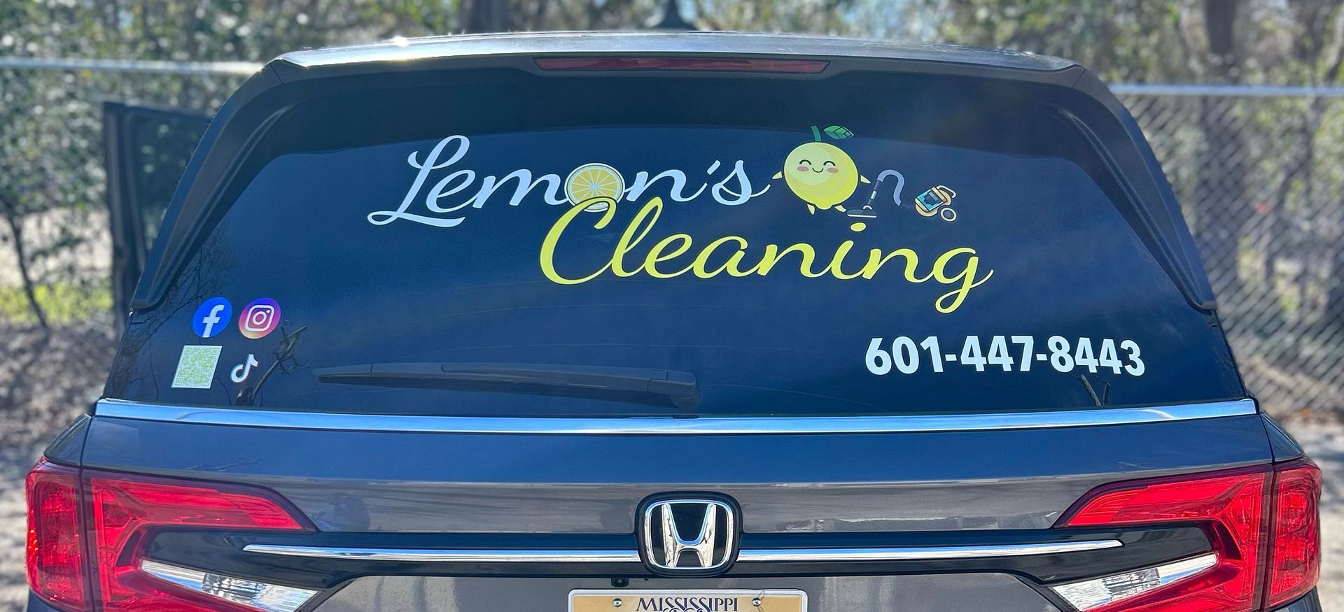 Back of a car featuring the business name 