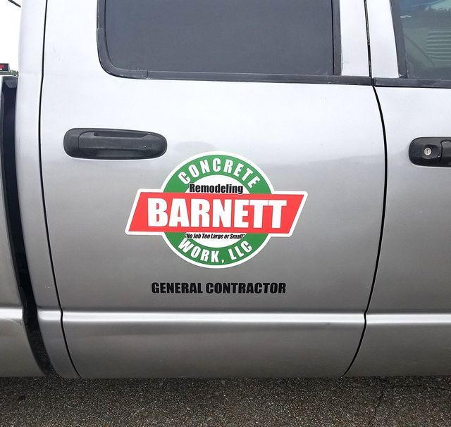 Silver truck door with a circular green and white logo reading 