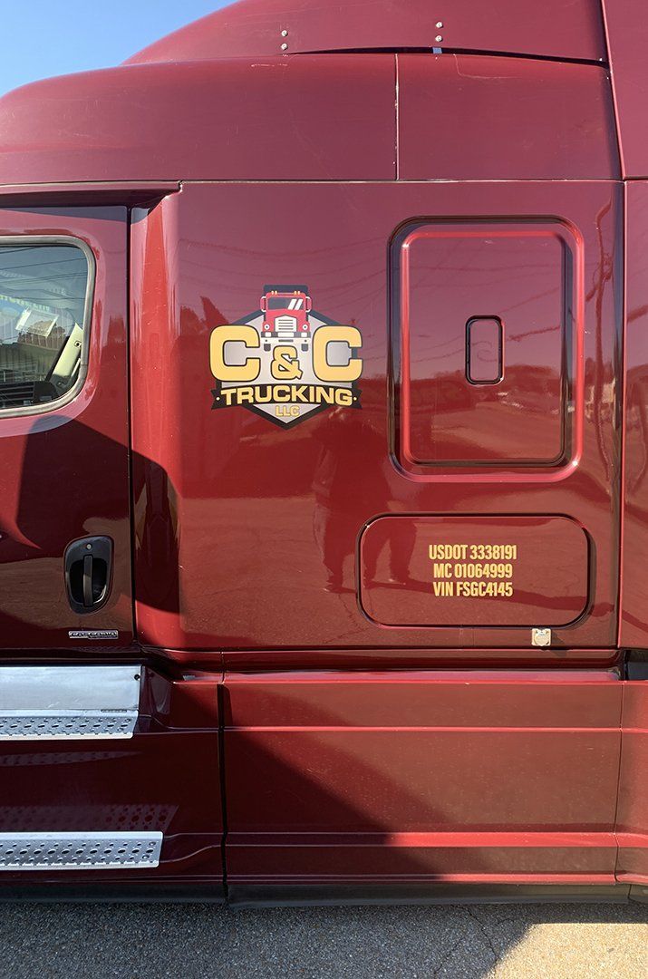 Maroon semi-truck cab with a gold 