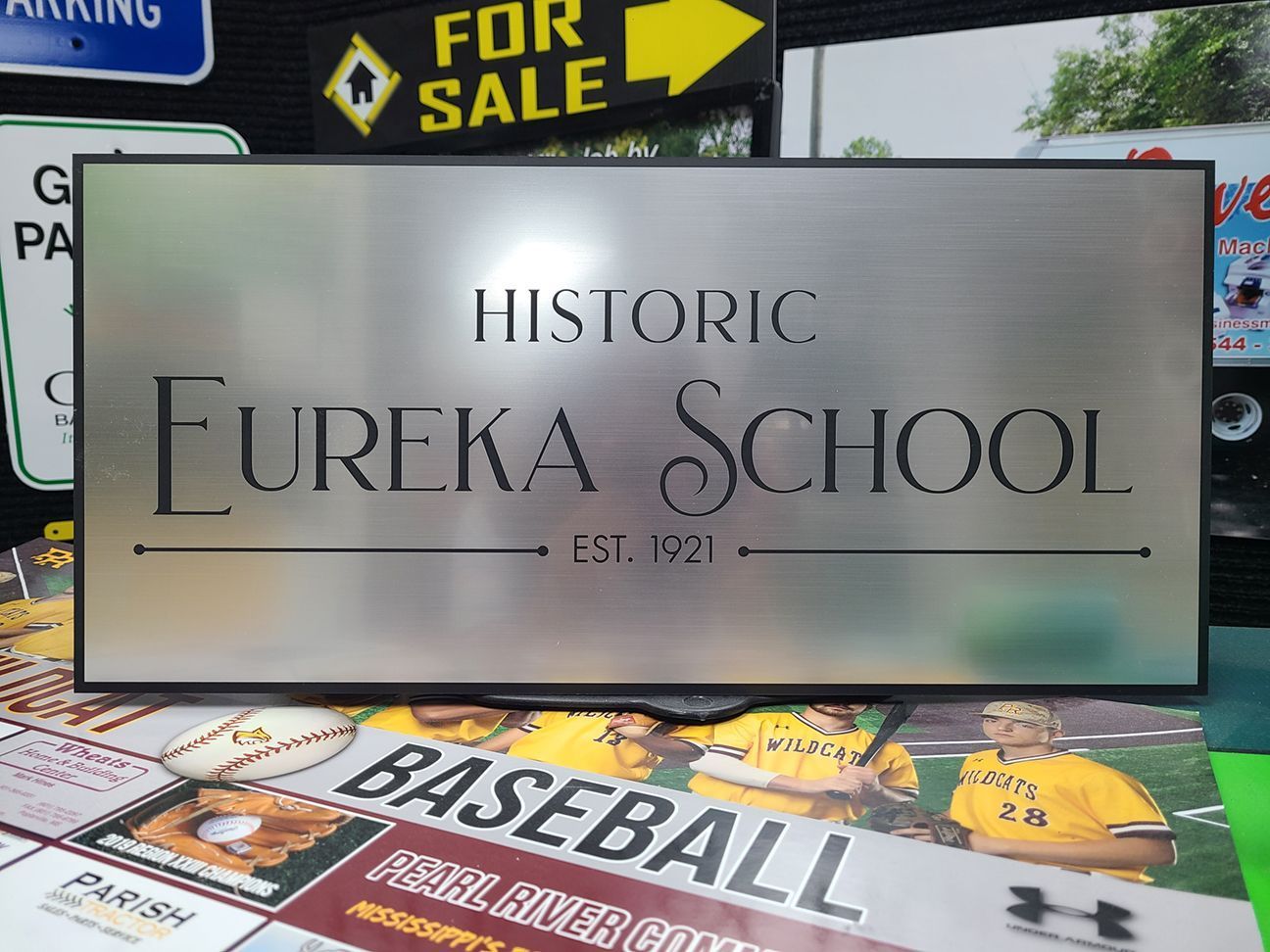 A brushed metal sign reading