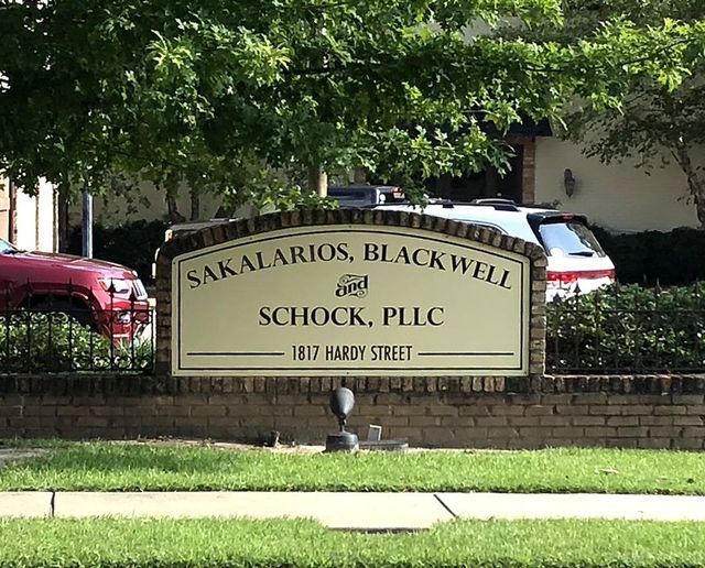 A brick-mounted sign reading 
