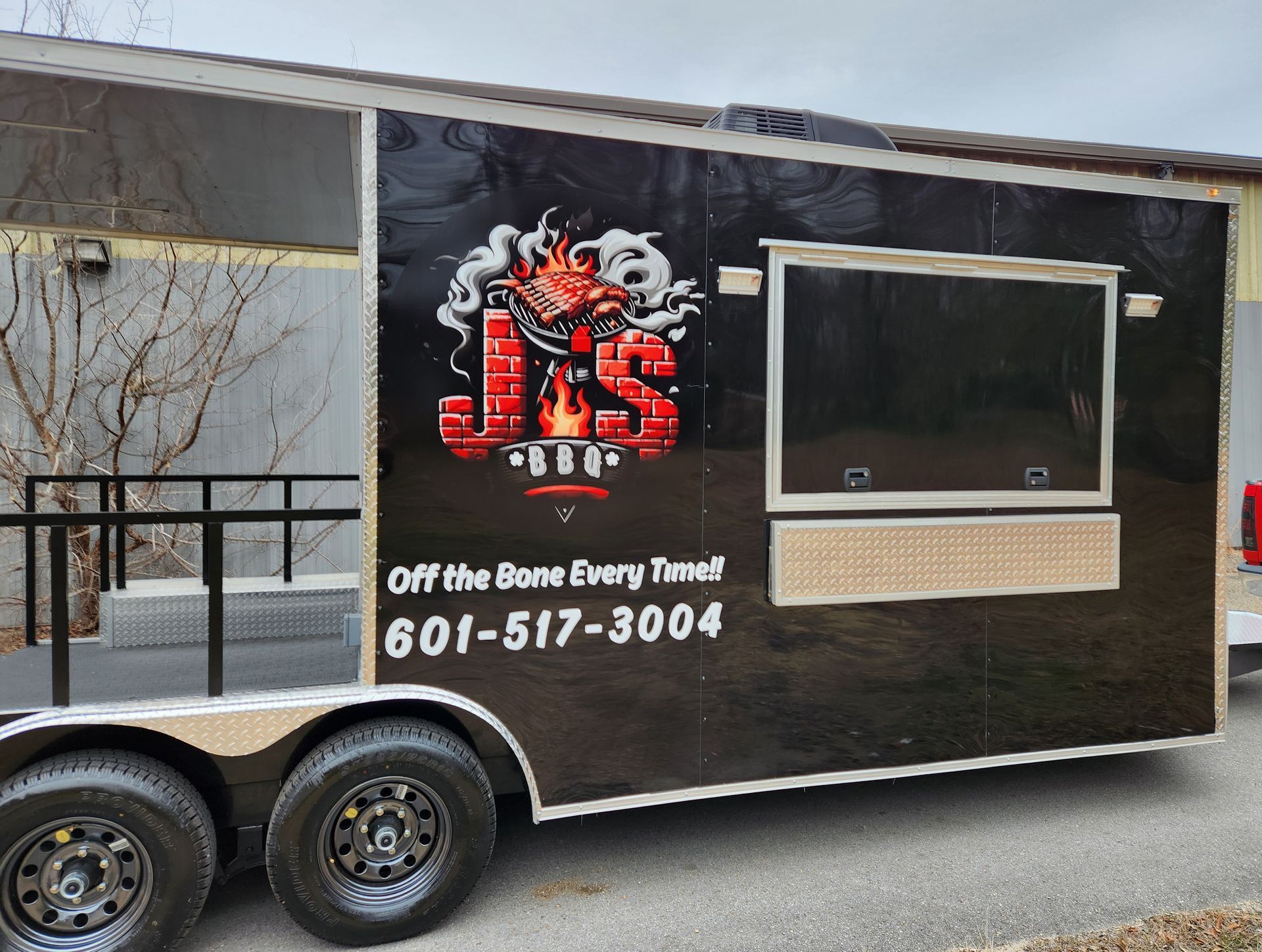 A black food trailer with a 