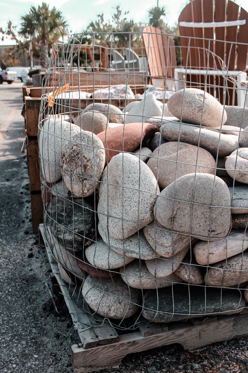 a pile of rocks sitting on top of a dirt field .