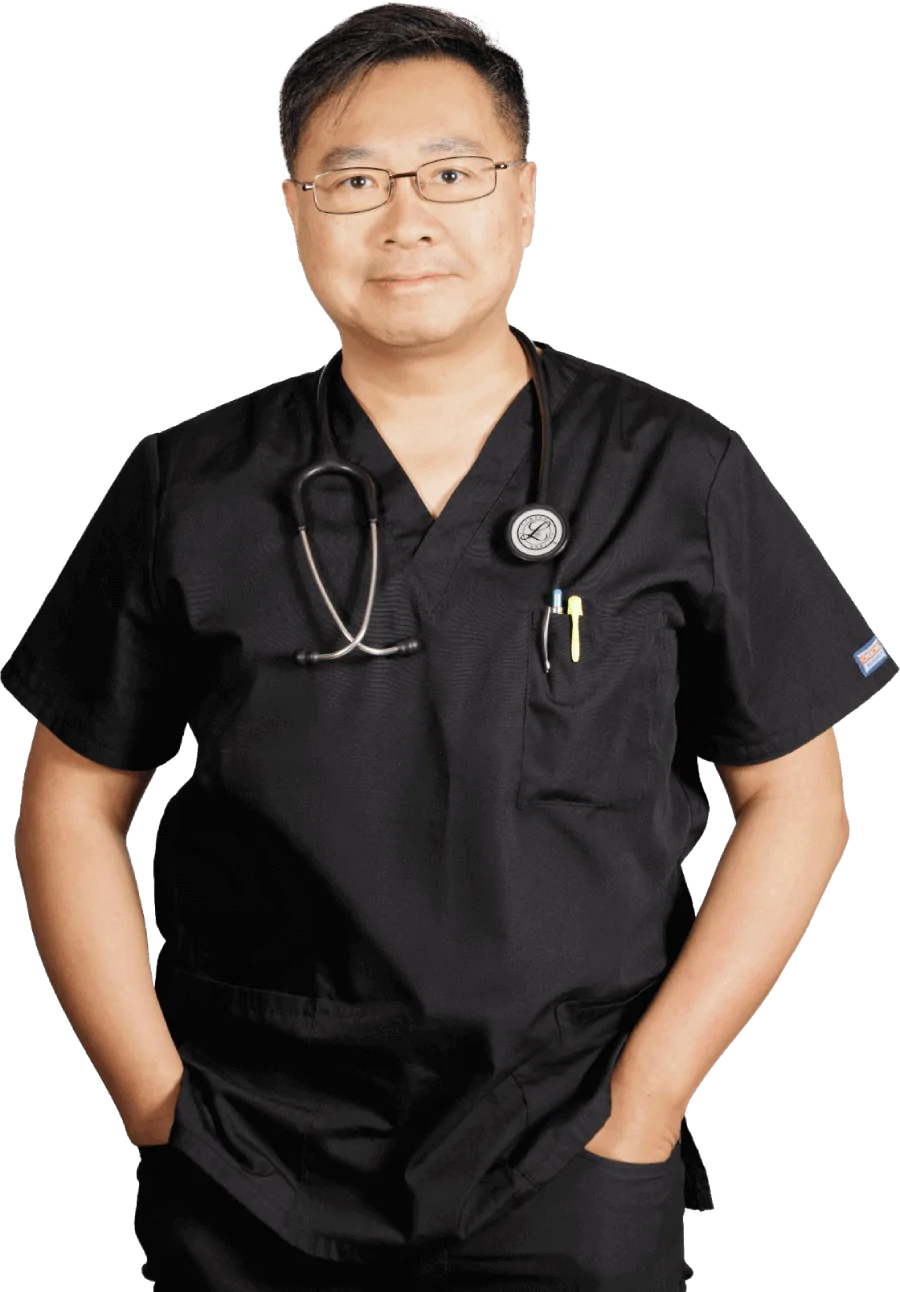 A man wearing a black scrub top with a stethoscope around his neck
