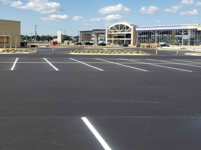 A parking lot with a building in the background