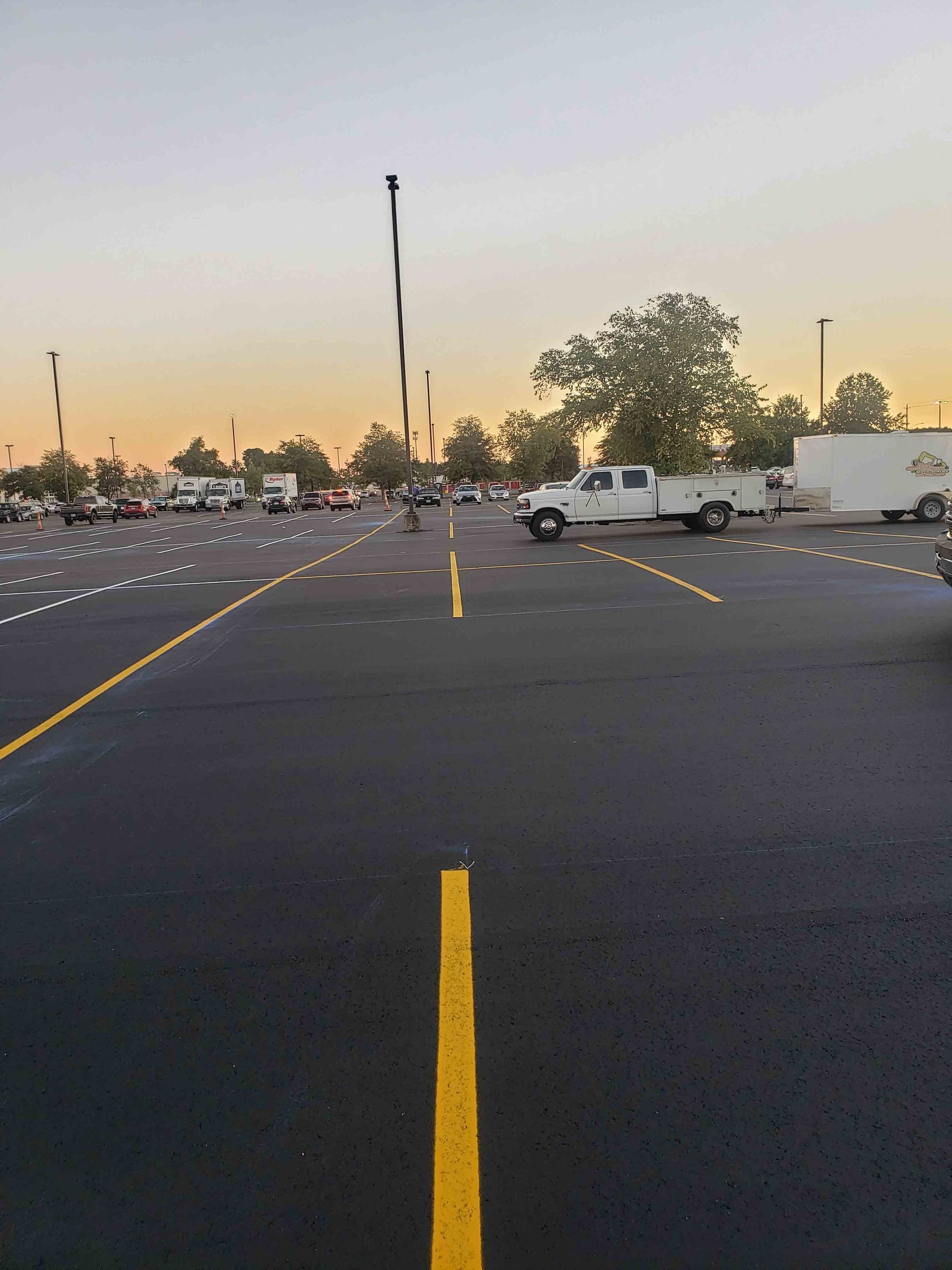 A parking lot with a white truck parked in the middle of it.