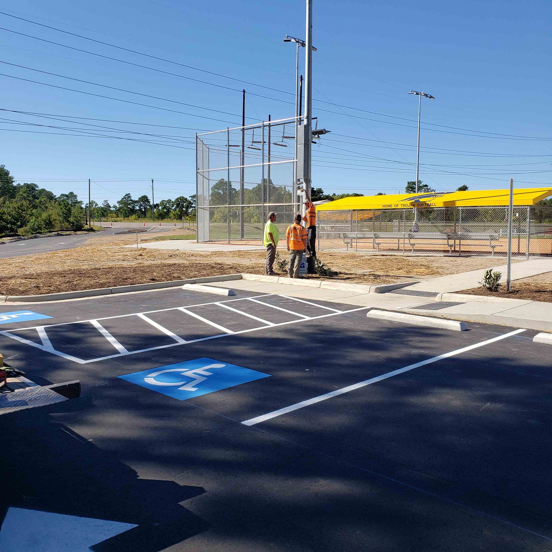 A handicapped parking spot is painted on the side of the road
