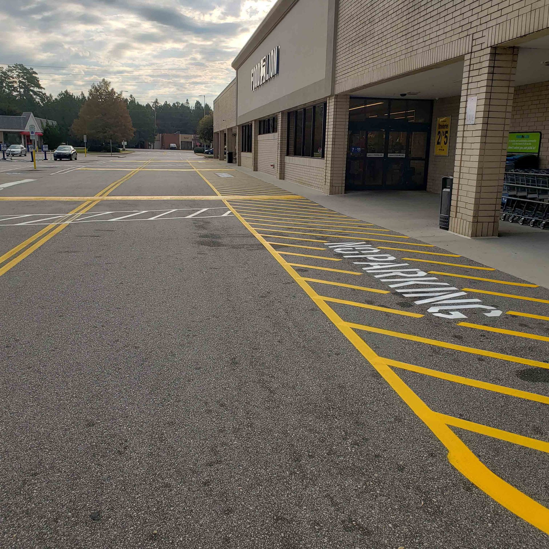 A parking lot in front of a store with a handicapped parking spot