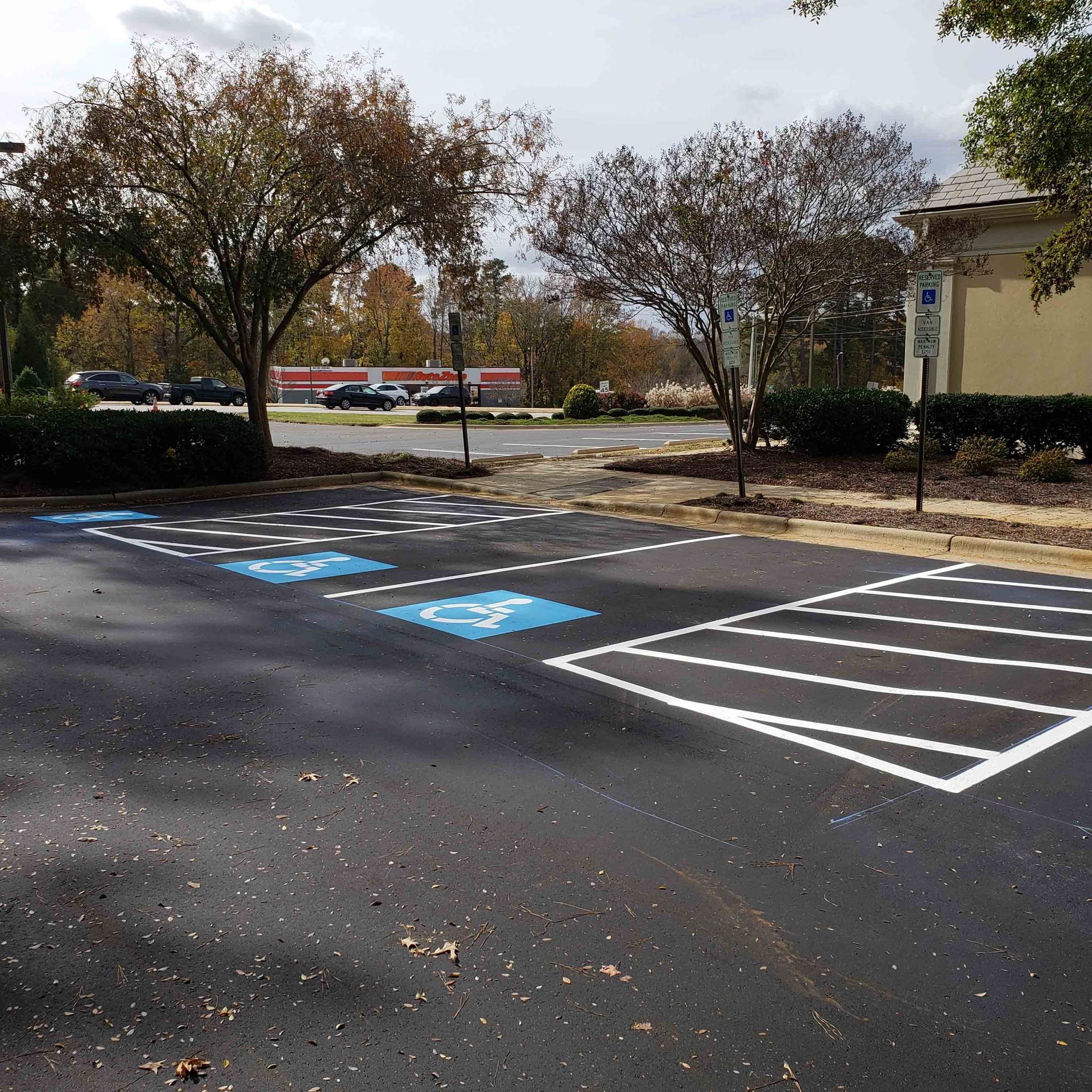 A parking lot with a handicapped parking spot in the middle