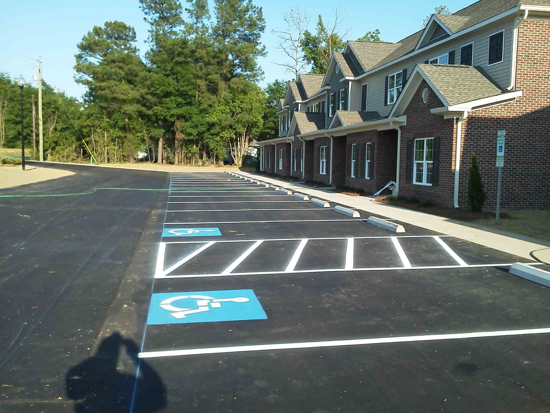 A parking lot with a handicap sign in the middle