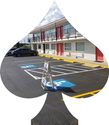 A spade shaped parking lot with a handicap sign