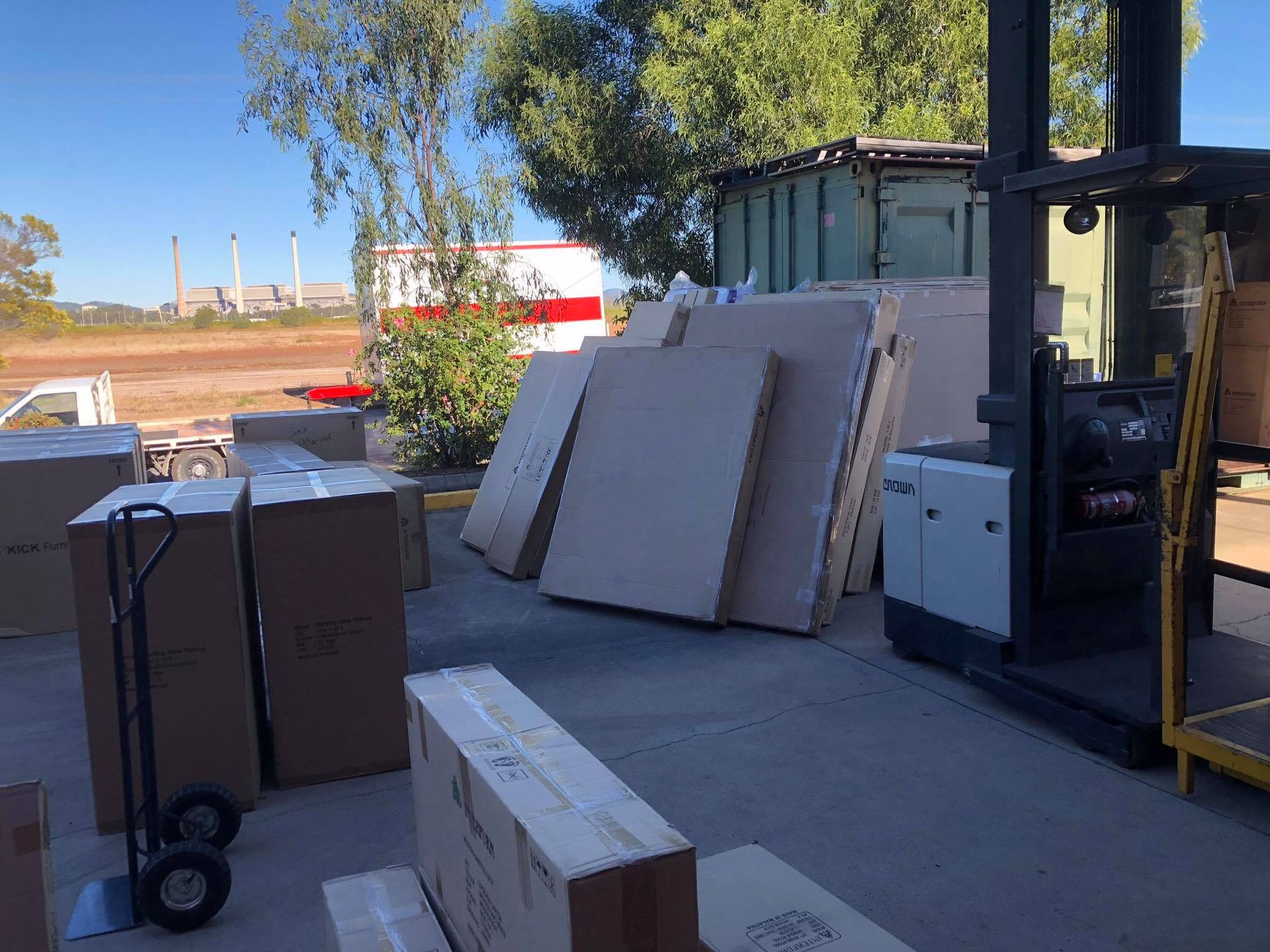 A forklift is loading boxes into a truck in a warehouse — Roderick Removals & Van Lines In Tannum Sands, QLD