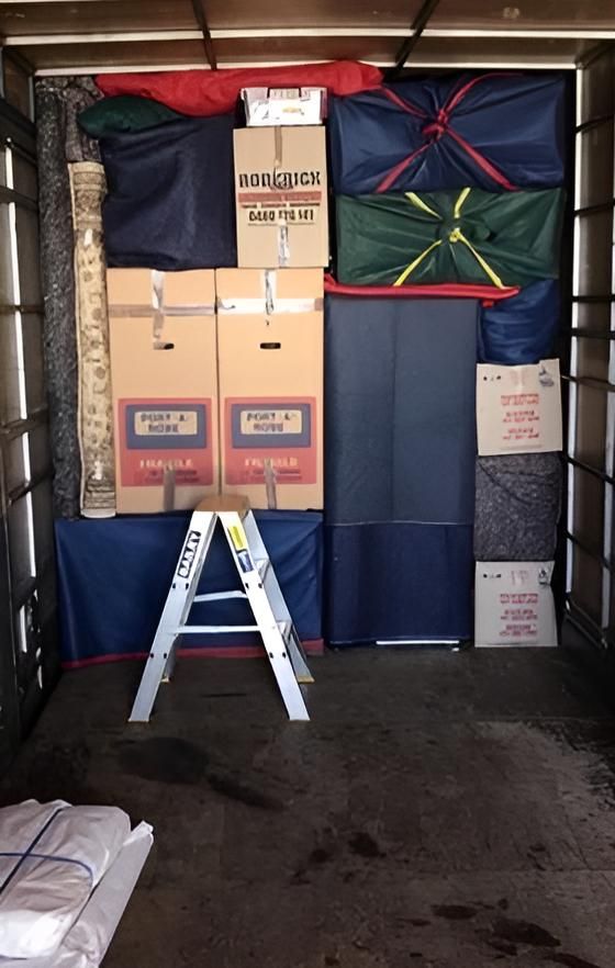 A Ladder is in the Back of a Moving Truck Filled With Boxes — Roderick Removals & Van Lines In Cairns, NSW