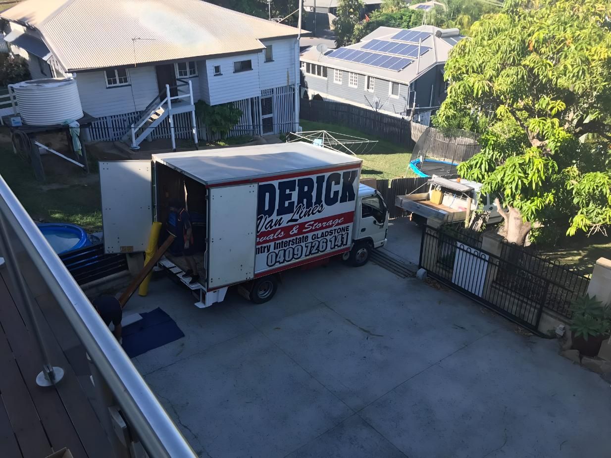 A Moving Truck is Parked in Front of a House — Roderick Removals & Van Lines In Airlie Beach, QLD