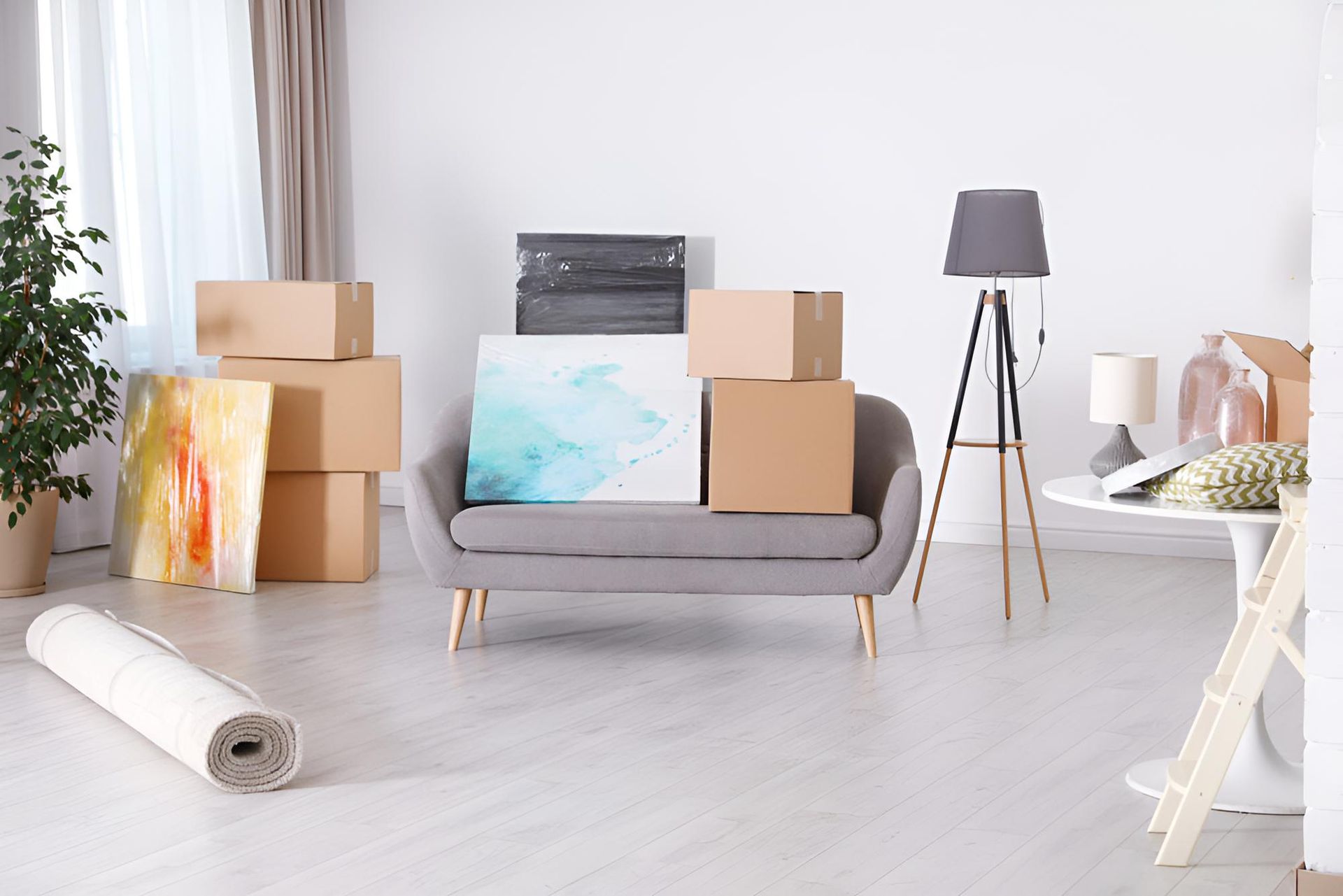 A Living Room Filled With Boxes and a Couch — Roderick Removals & Van Lines In Airlie Beach, QLD