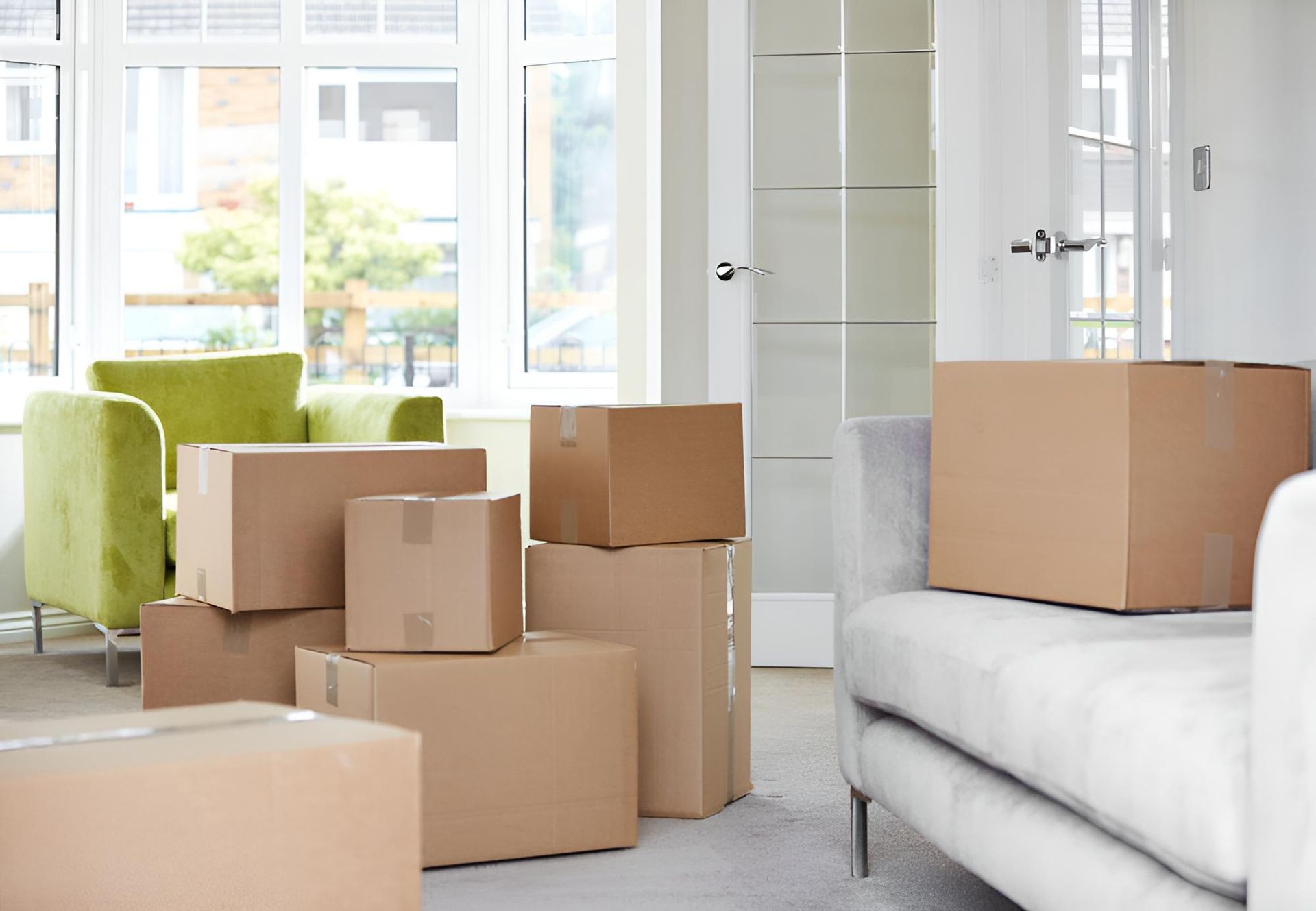 A Living Room Filled With Cardboard Boxes and a Couch — Roderick Removals & Van Lines In Bundaberg, QLD