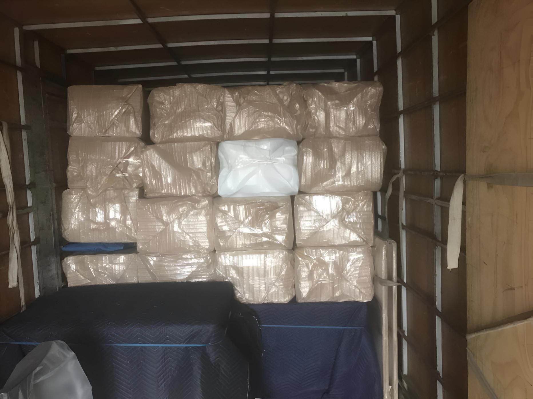 The Inside of a Truck Filled With Boxes Wrapped in Plastic — Roderick Removals & Van Lines In Airlie Beach, QLD