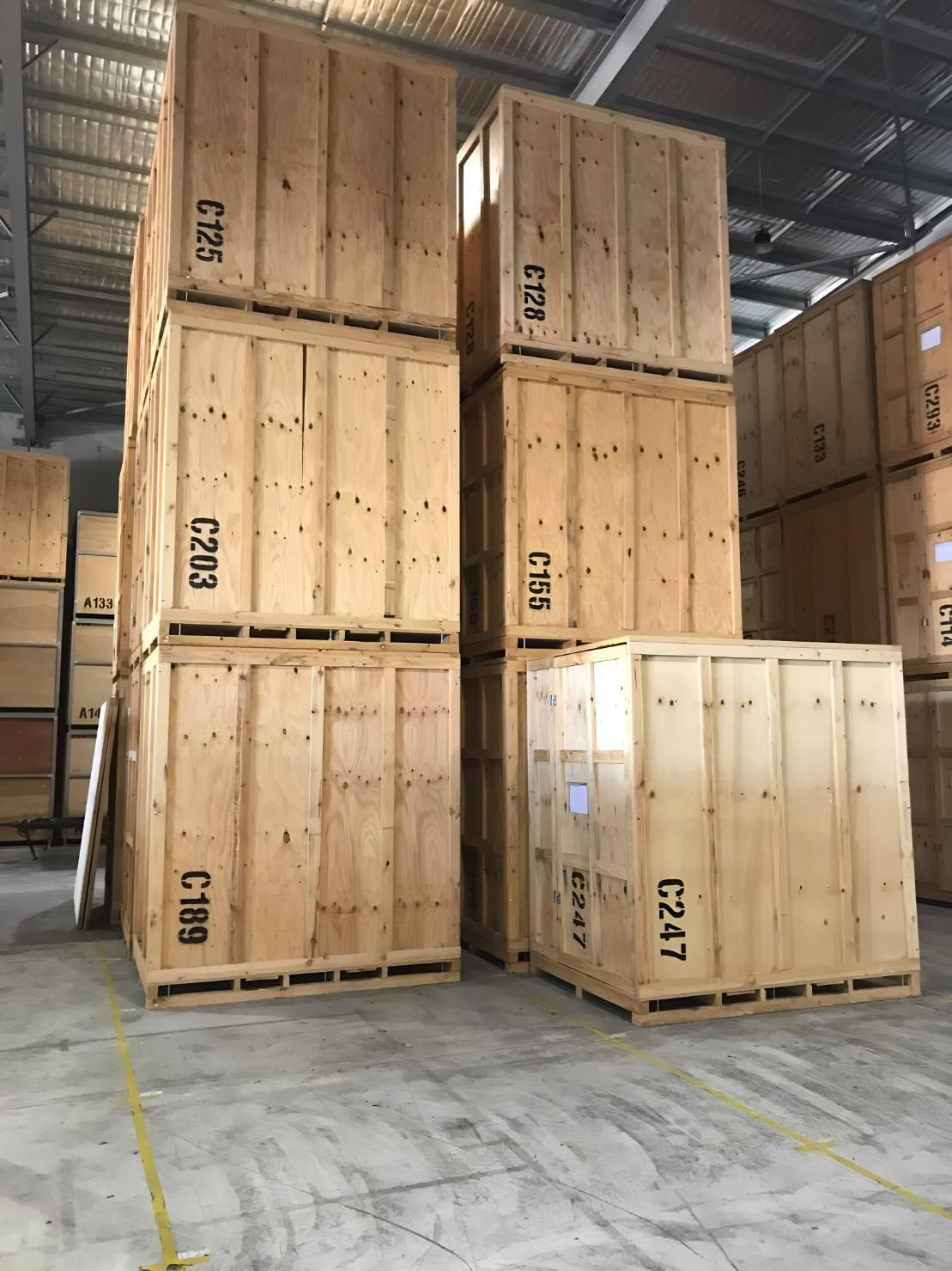 A Bunch of Wooden Boxes Are Stacked on Top of Each Other in a Warehouse — Roderick Removals & Van Lines In Townsville, QLD
