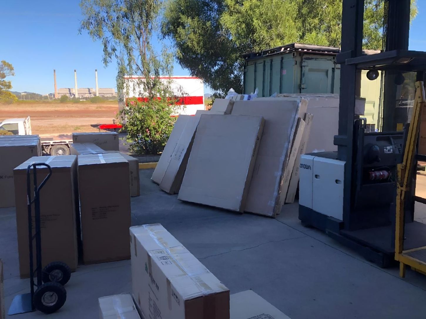 a Lot of Boxes Are Stacked on Top of Each Other in a Parking Lot — Roderick Removals & Van Lines In Emerald, QLD