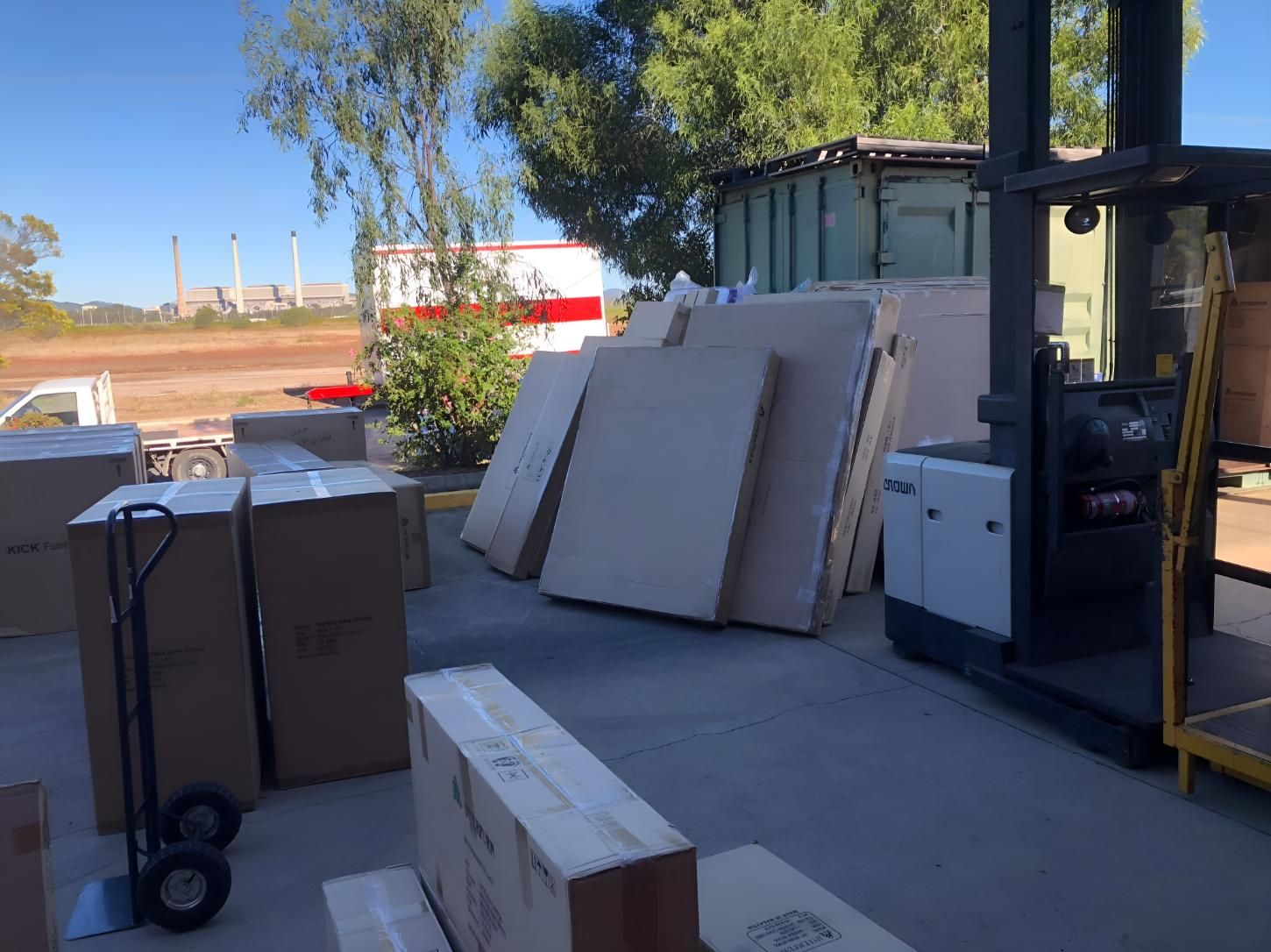 A Lot of Boxes Are Stacked on Top of Each Other in a Parking Lot — Roderick Removals & Van Lines In Bowen, QLD