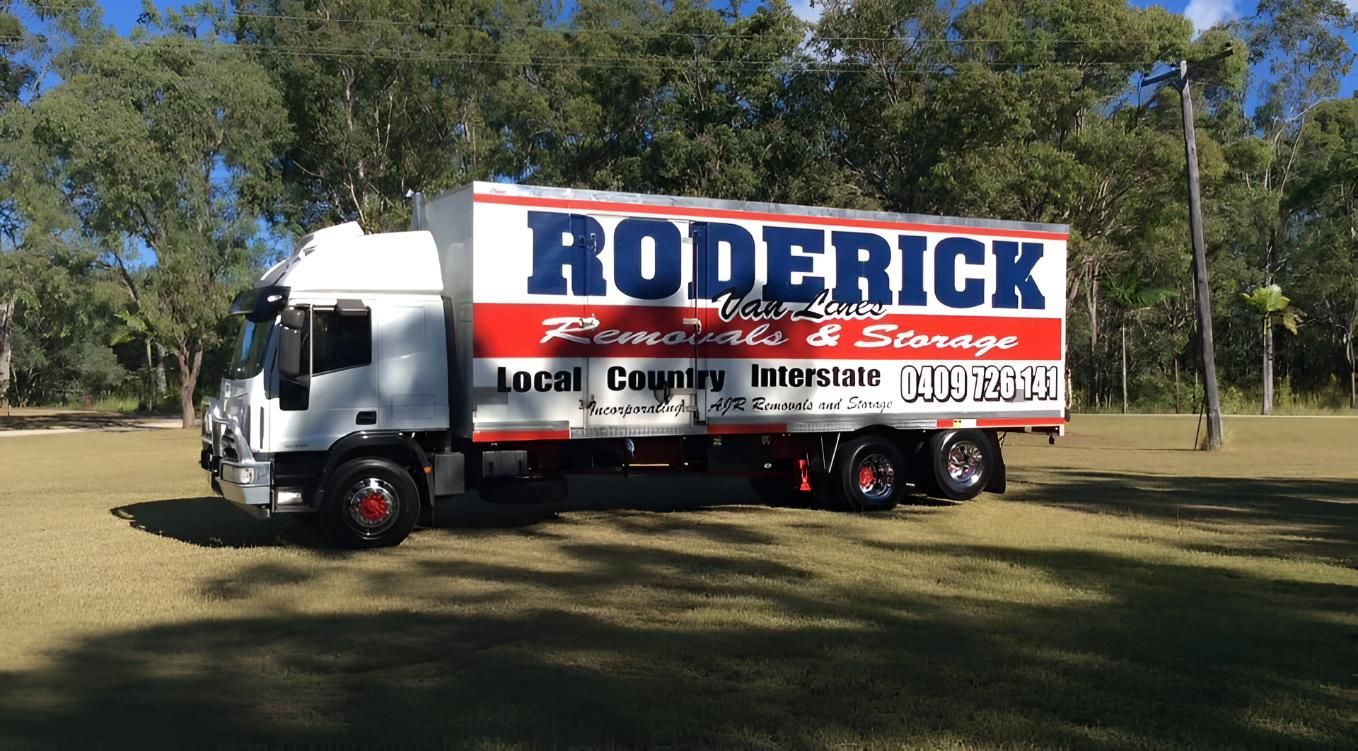 A Roderick Moving Truck is Parked in a Grassy Field — Roderick Removals & Van Lines In Boyne Island, QLD