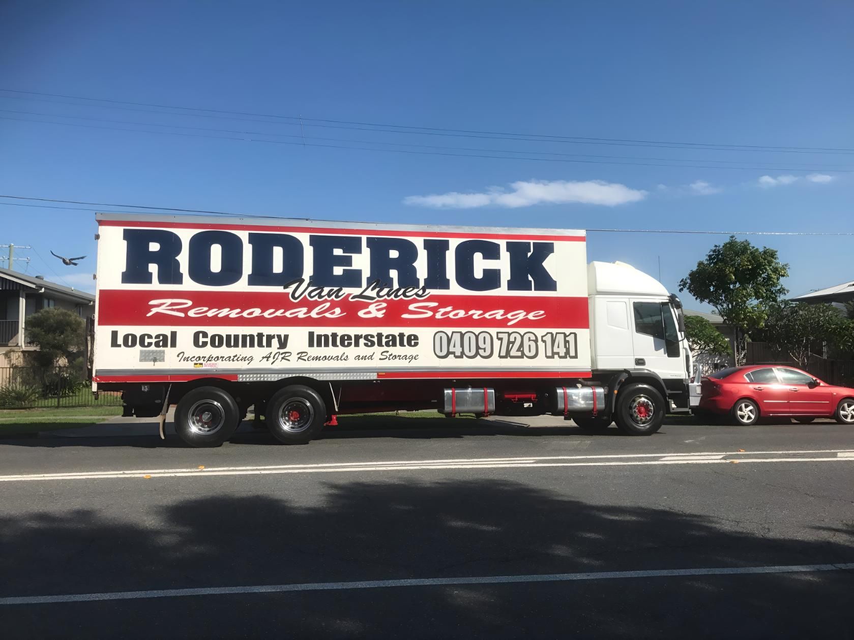 A Roderick Moving Truck is Parked on the Side of the Road — Roderick Removals & Van Lines In Brisbane, QLD