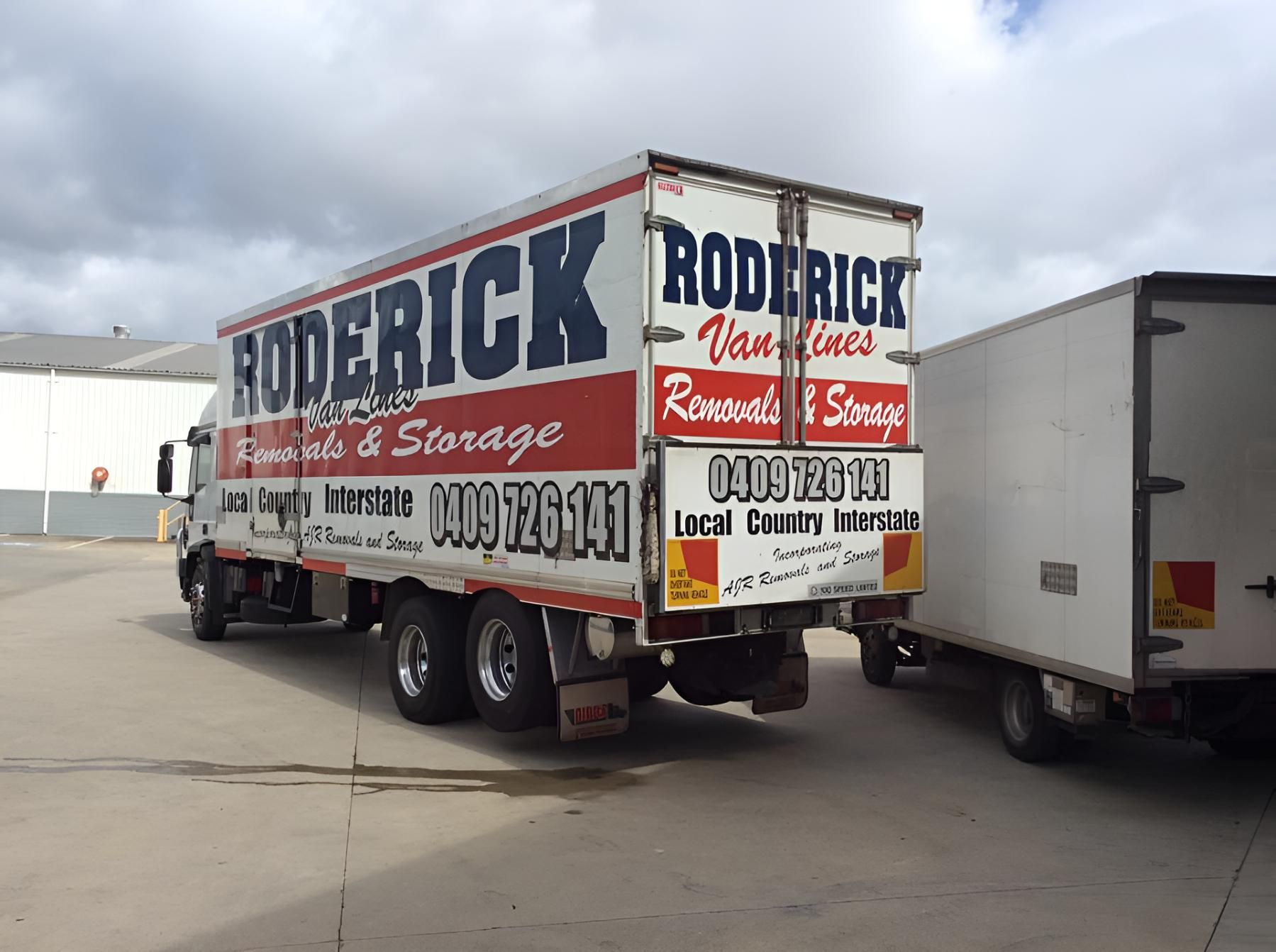 A Roderick Truck is Parked Next to Another Truck — Roderick Removals & Van Lines In Bundaberg, QLD