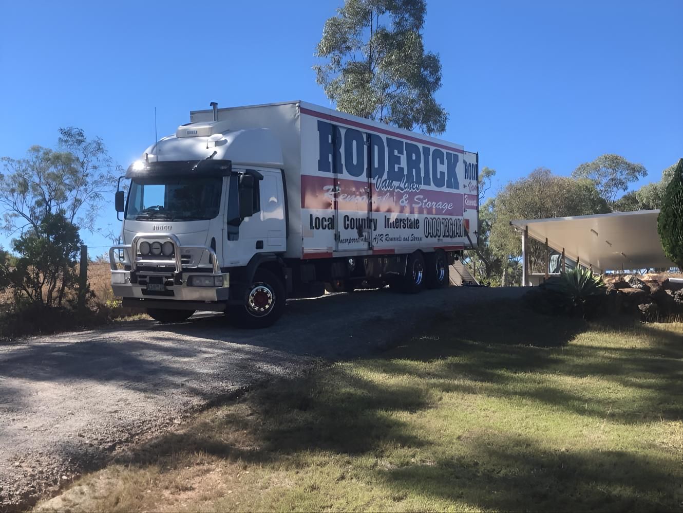 A Roderick Truck is Parked on the Side of the Road — Roderick Removals & Van Lines In Townsville, QLD