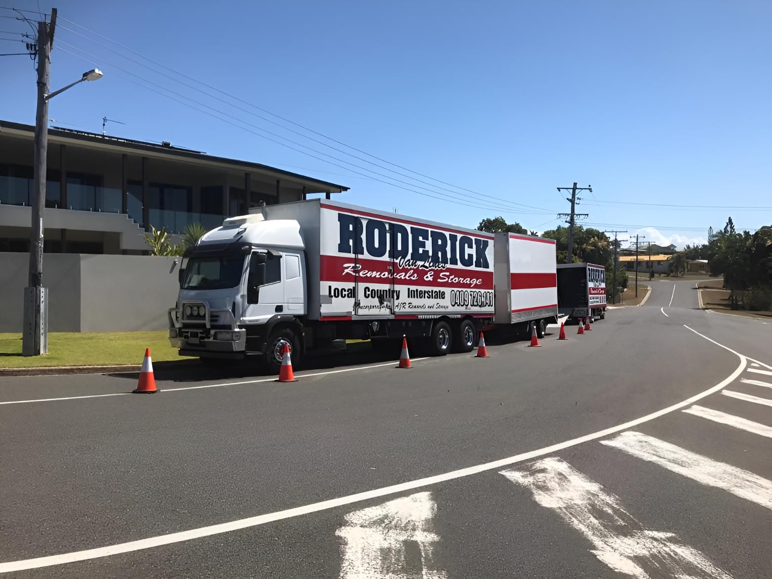 A Boderick Truck is Parked on the Side of the Road — Roderick Removals & Van Lines In Hervey Bay, QLD