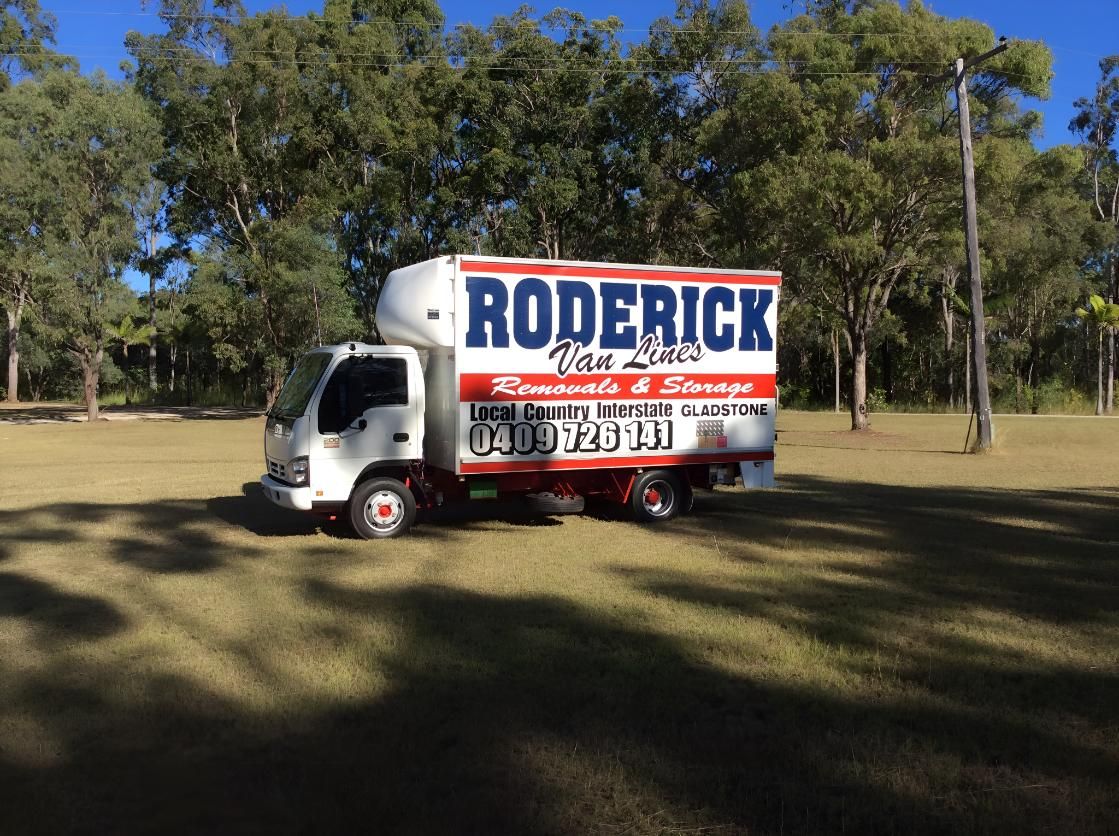 A Roderick Moving Truck is Parked in a Grassy Field — Roderick Removals & Van Lines In Gladstone Central, QLD