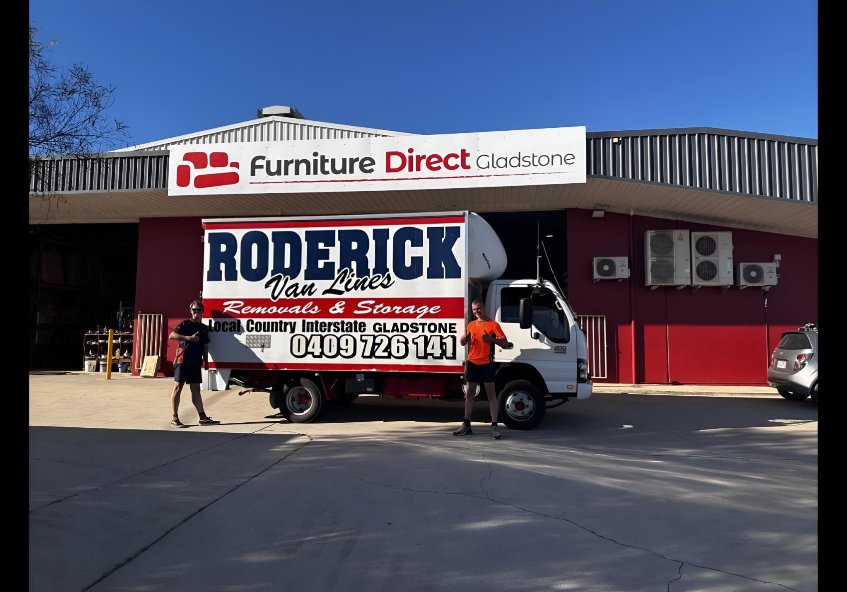 A Roderick Truck is Parked in Front of a Furniture Direct Store — Roderick Removals & Van Lines In Gladstone Central, QLD