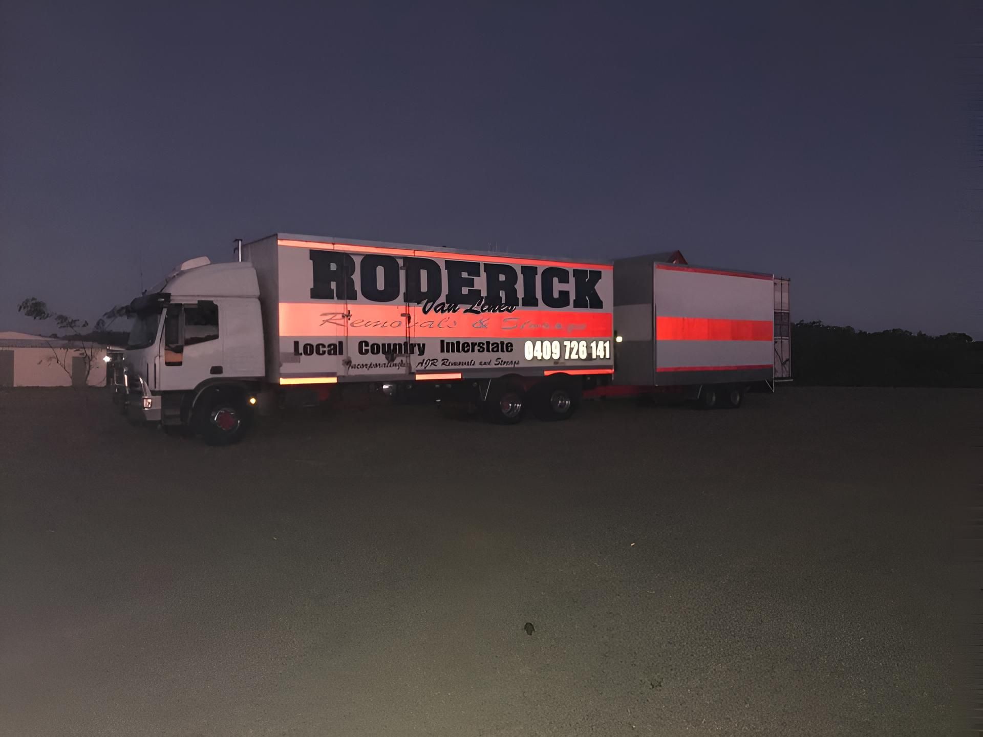 A Roderick Truck is Parked in a Dark Parking Lot — Roderick Removals & Van Lines In Gladstone Central, QLD