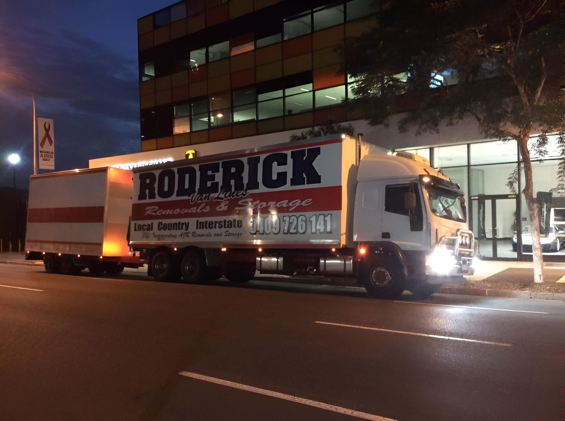 A Truck is Parked on the Side of the Road in Front of a Building — Roderick Removals & Van Lines In Gladstone Central, QLD