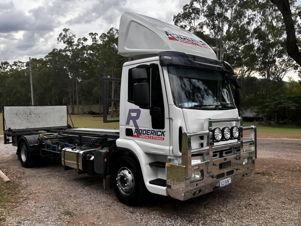 Truck With the Letter R on the Side is Parked in a Gravel Lot — Roderick Removals & Van Lines In Gladstone Central, QLD