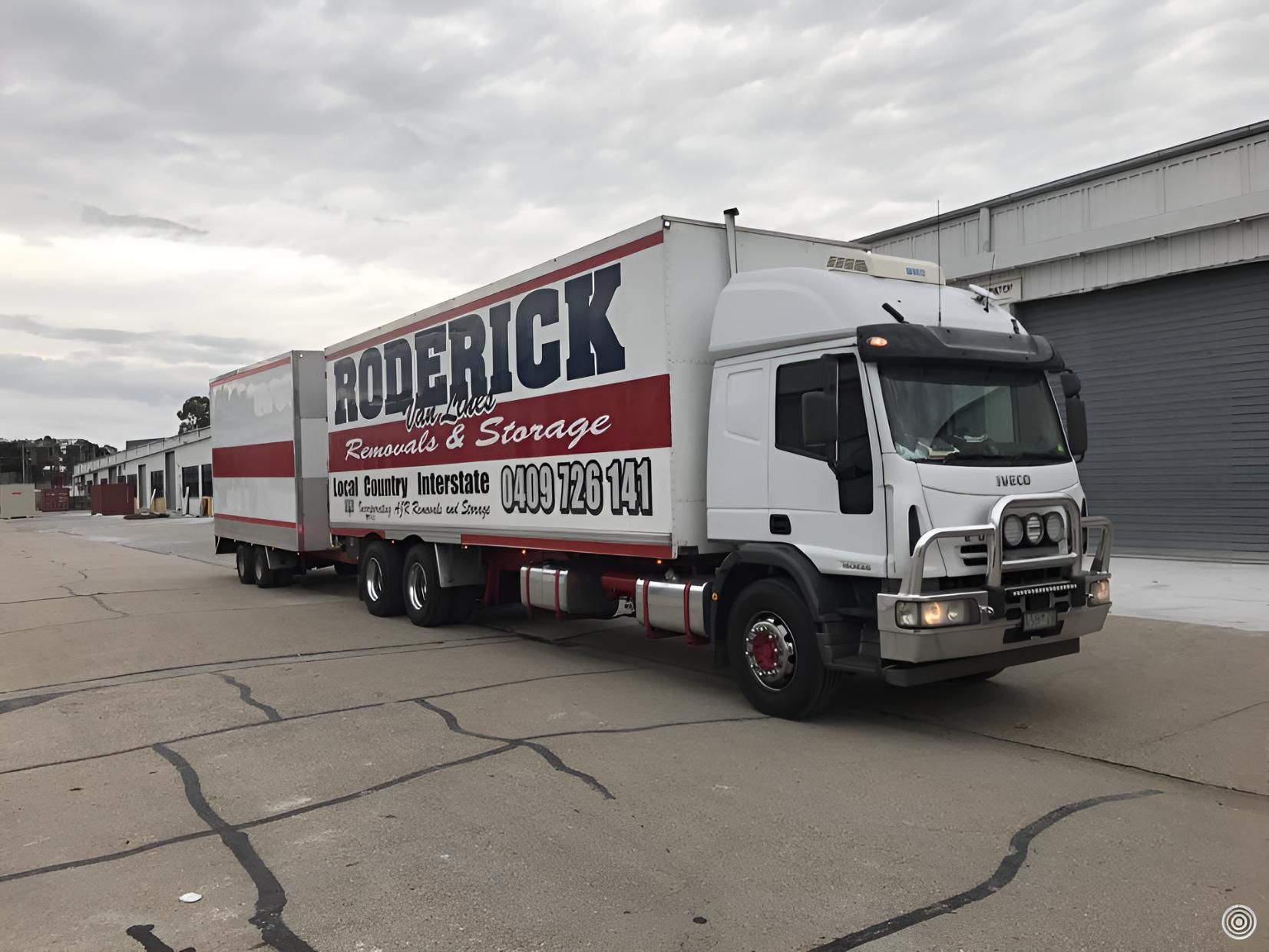 A Roderick Truck is Parked in Front of a Building — Roderick Removals & Van Lines In Sunshine Coast, QLD