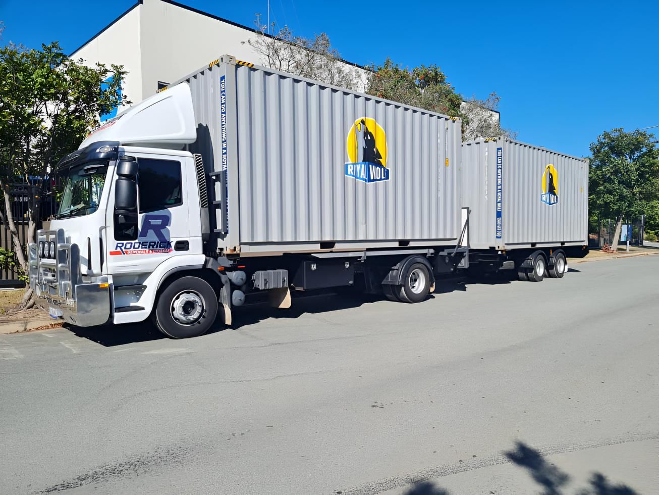 A Truck Shipping Containers Attached to It is Parked on the Side of the Road — Roderick Removals & Van Lines In Emerald, QLD