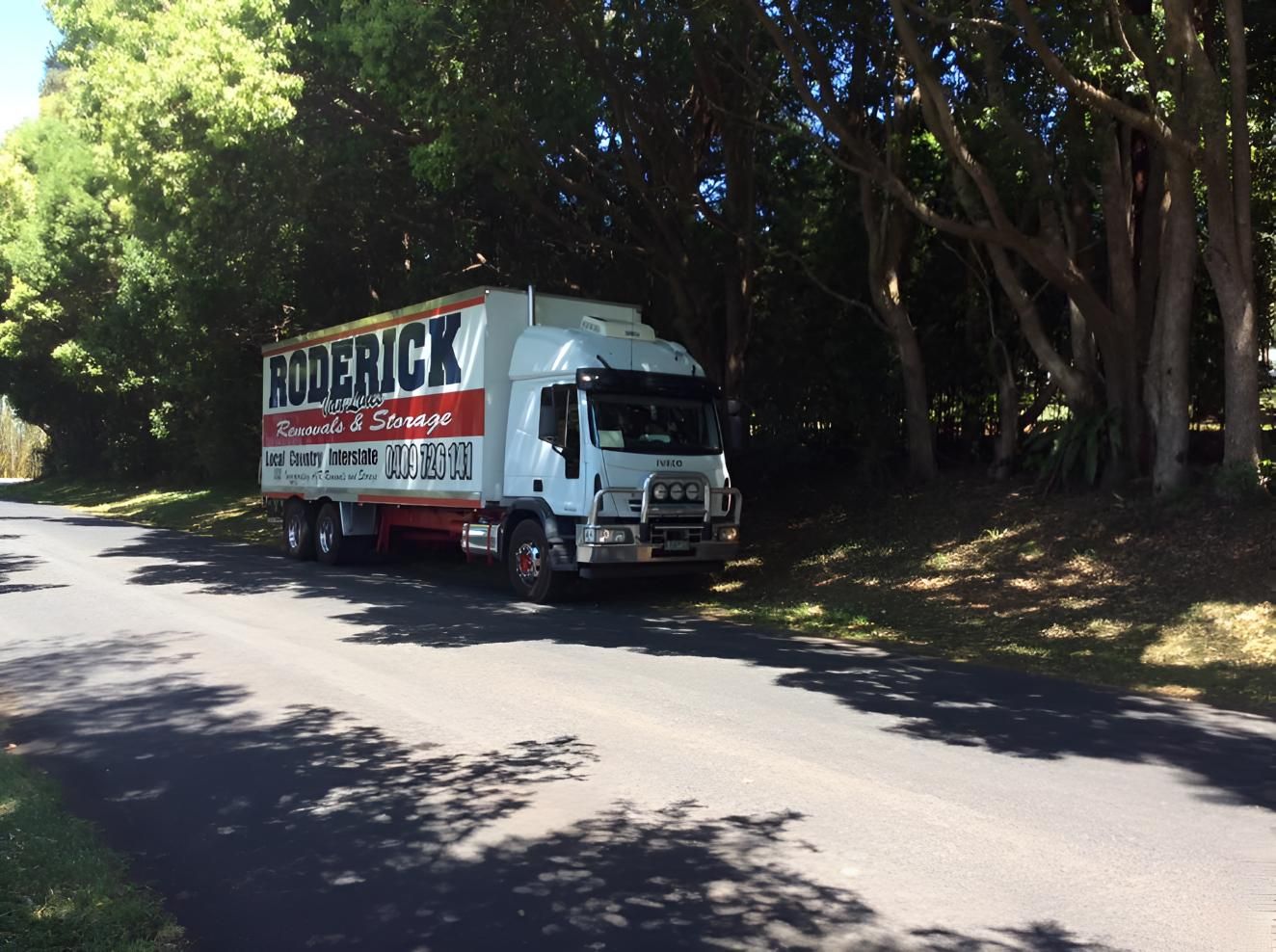 A White Truck With the Word Roderick on the Side is Driving Down a Road — Roderick Removals & Van Lines In Tannum Sands, QLD