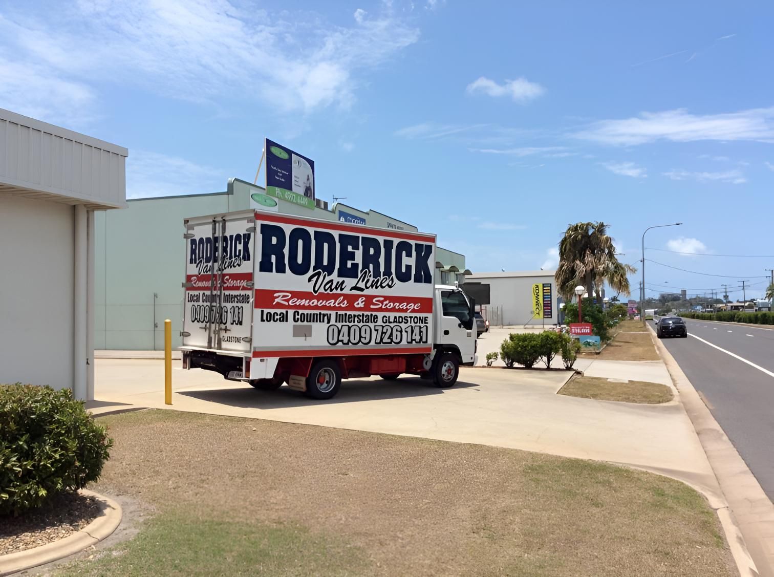 A Roderick Moving Truck is Parked in Front of a Building — Roderick Removals & Van Lines In Mackay, QLD