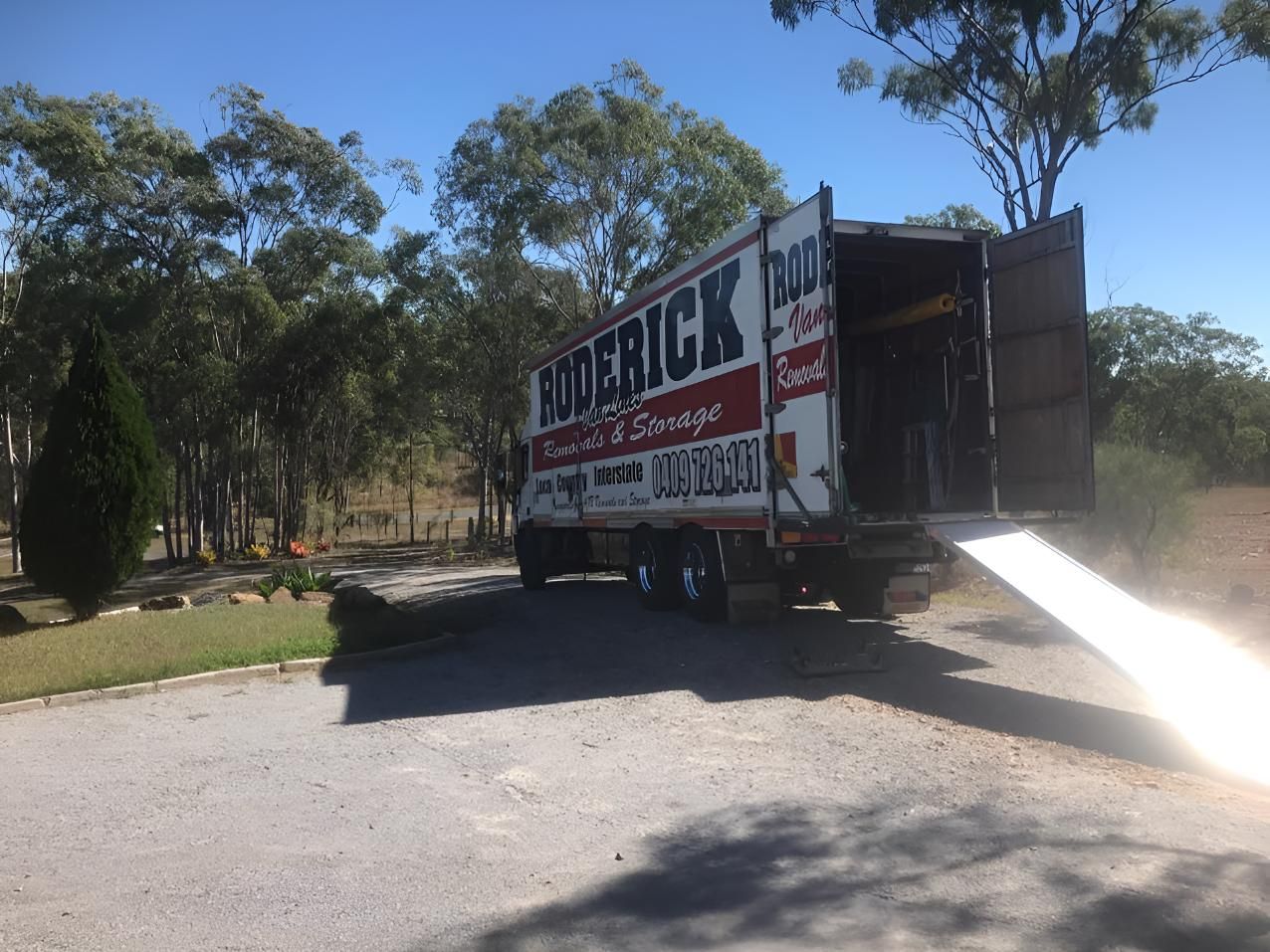 A Moving Truck is Parked on the Side of the Road — Roderick Removals & Van Lines In Airlie Beach, QLD