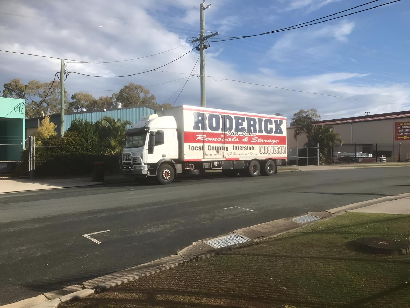 A Roderick Truck is Parked on the Side of the Road — Roderick Removals & Van Lines In Bowen, QLD