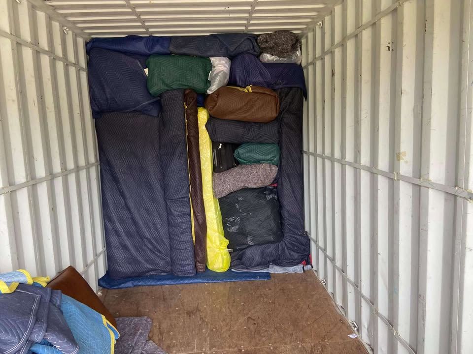 A large warehouse filled with lots of boxes and bags — Roderick Removals & Van Lines In Gladstone Central, QLD